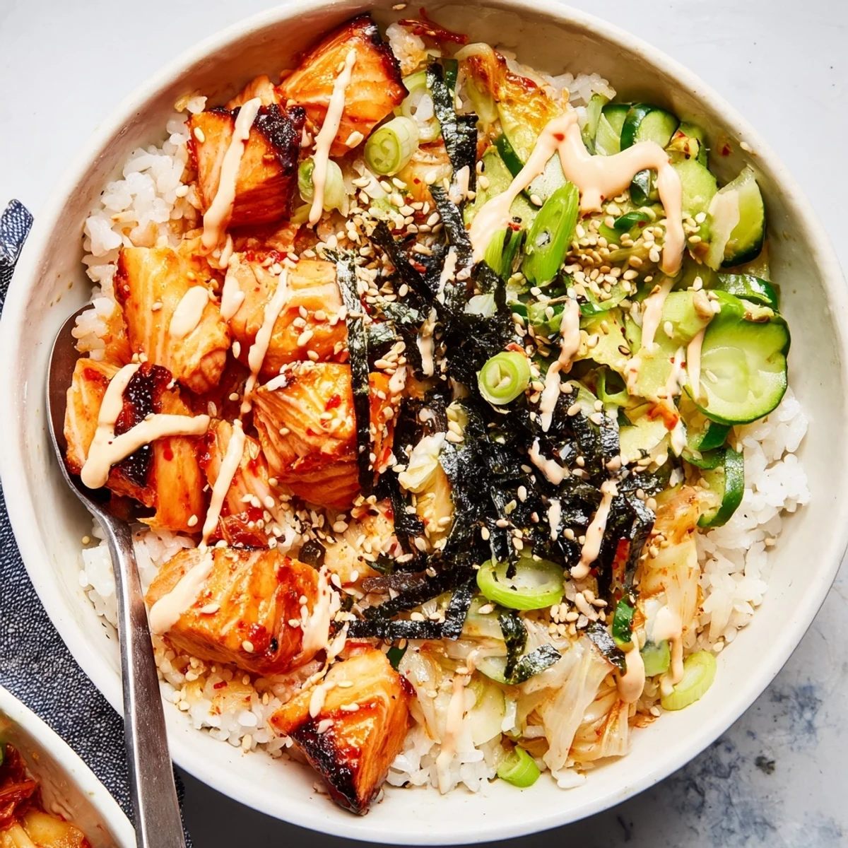 Savor the textures in this crispy salmon rice bowl with spicy mayo and tasty toppings.