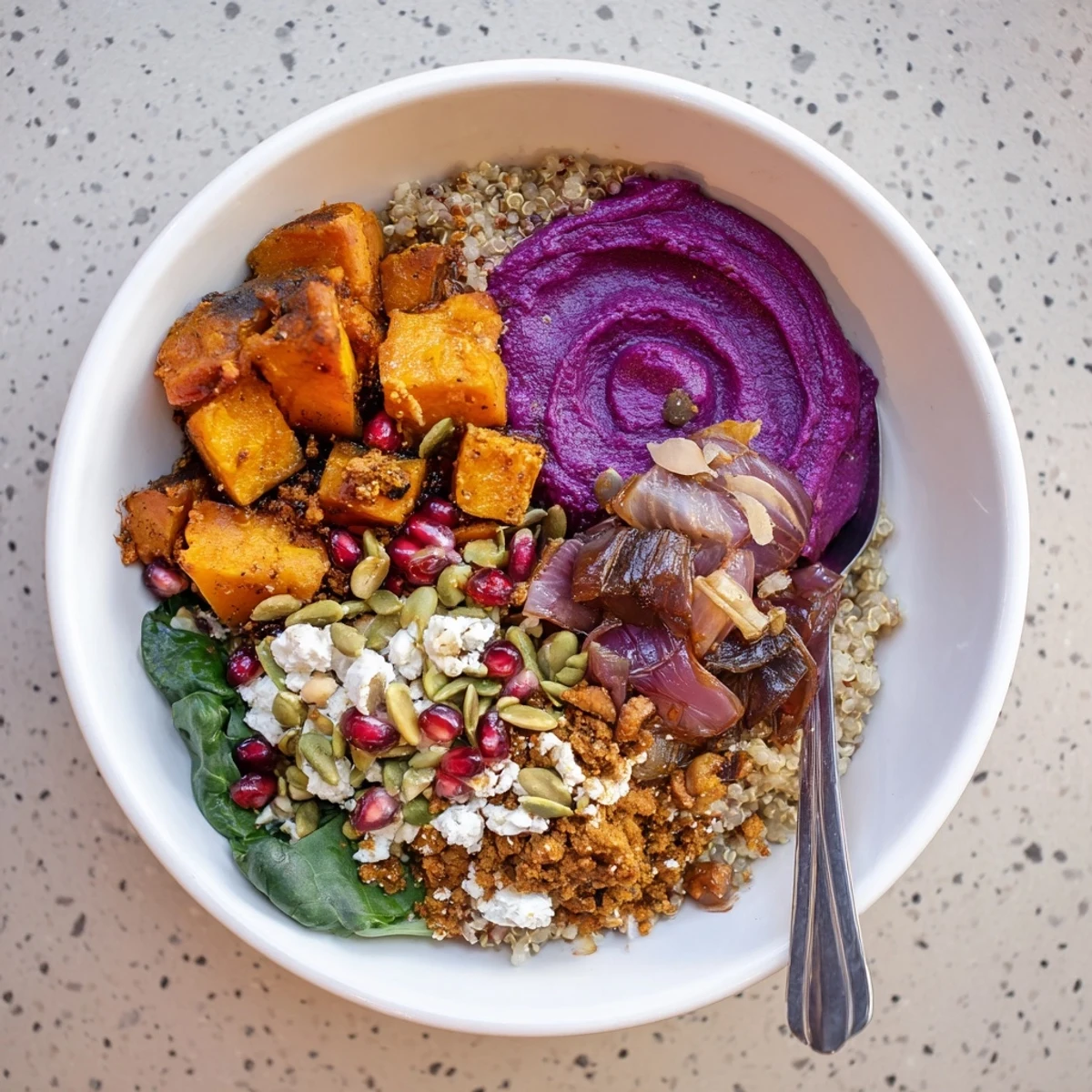 A vibrant Spiced Winter Bowls filled with roasted veggies and ube-coconut purée.  