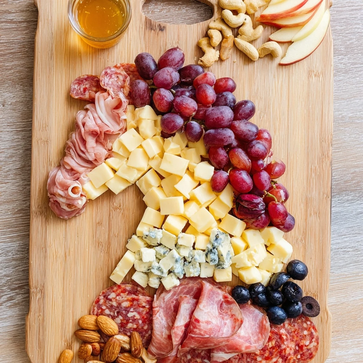 This stunning horse-shaped grazing board features an array of cheeses, meats, and colorful accompaniments for a party!