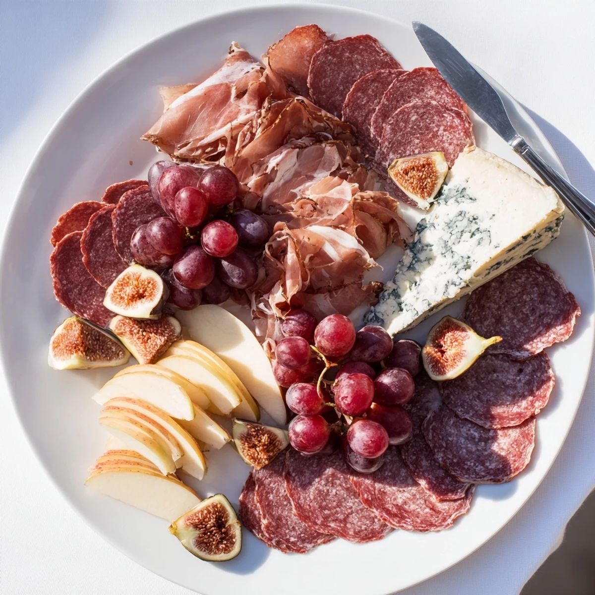 This Majestic Venison Charcuterie Platter is a delicious gathering of savory venison, cheeses, and grapes, arranged beautifully.