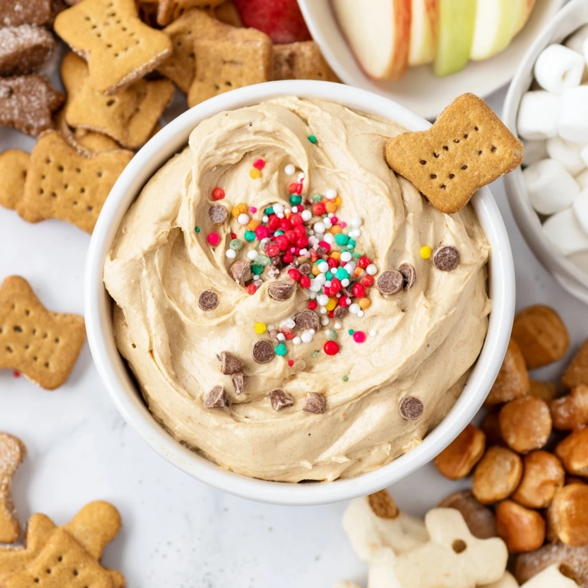 A festive Gingerbread House Dip Board, showcasing the creamy dip alongside gingerbread cookies and pretzels.