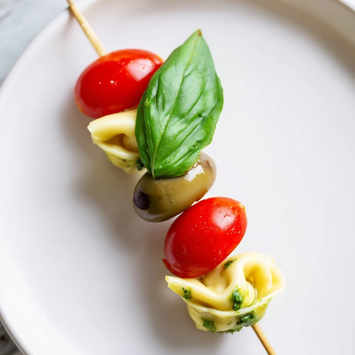 Freshly made Appetizer Skewers, showcasing tortellini, olives, and pesto, perfect for any gathering's flavors.