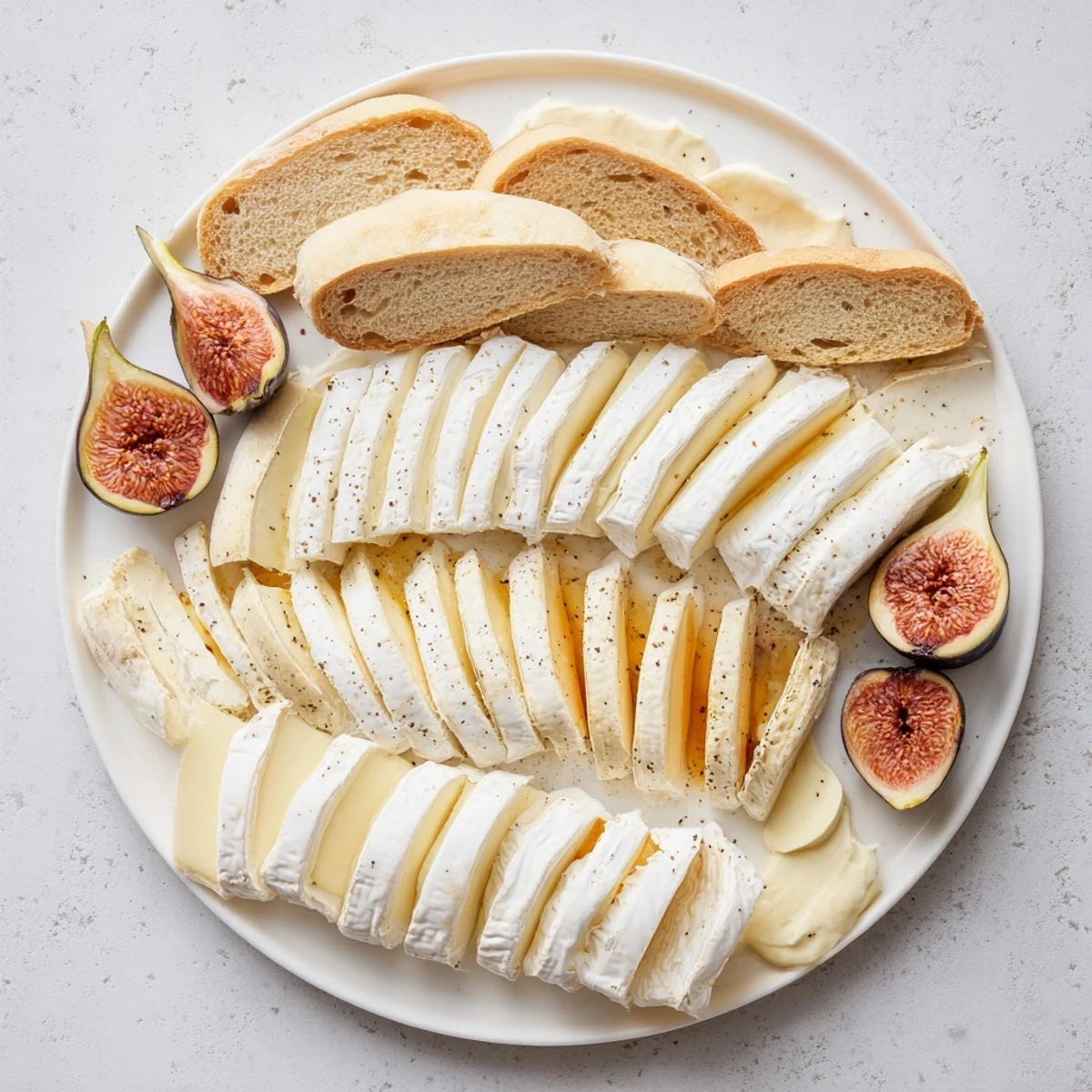 French Bistro Elegance platter with artisan baguettes, cheeses, fresh figs, and accompaniments, ready to serve.