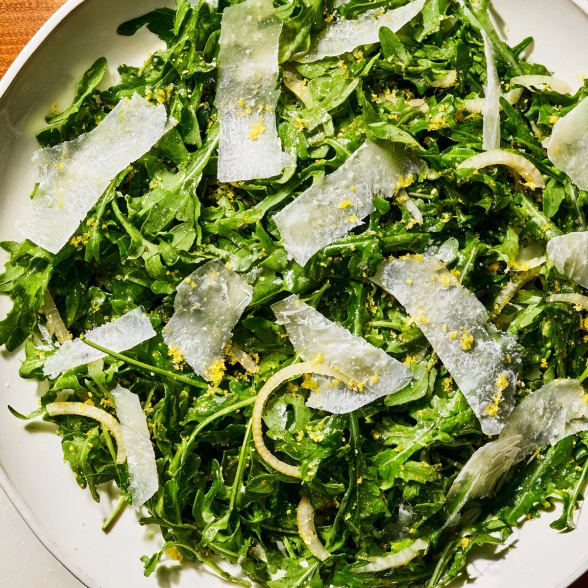 Close-up of a refreshing arugula salad with lemon dressing, inviting you to enjoy its Italian flavors.