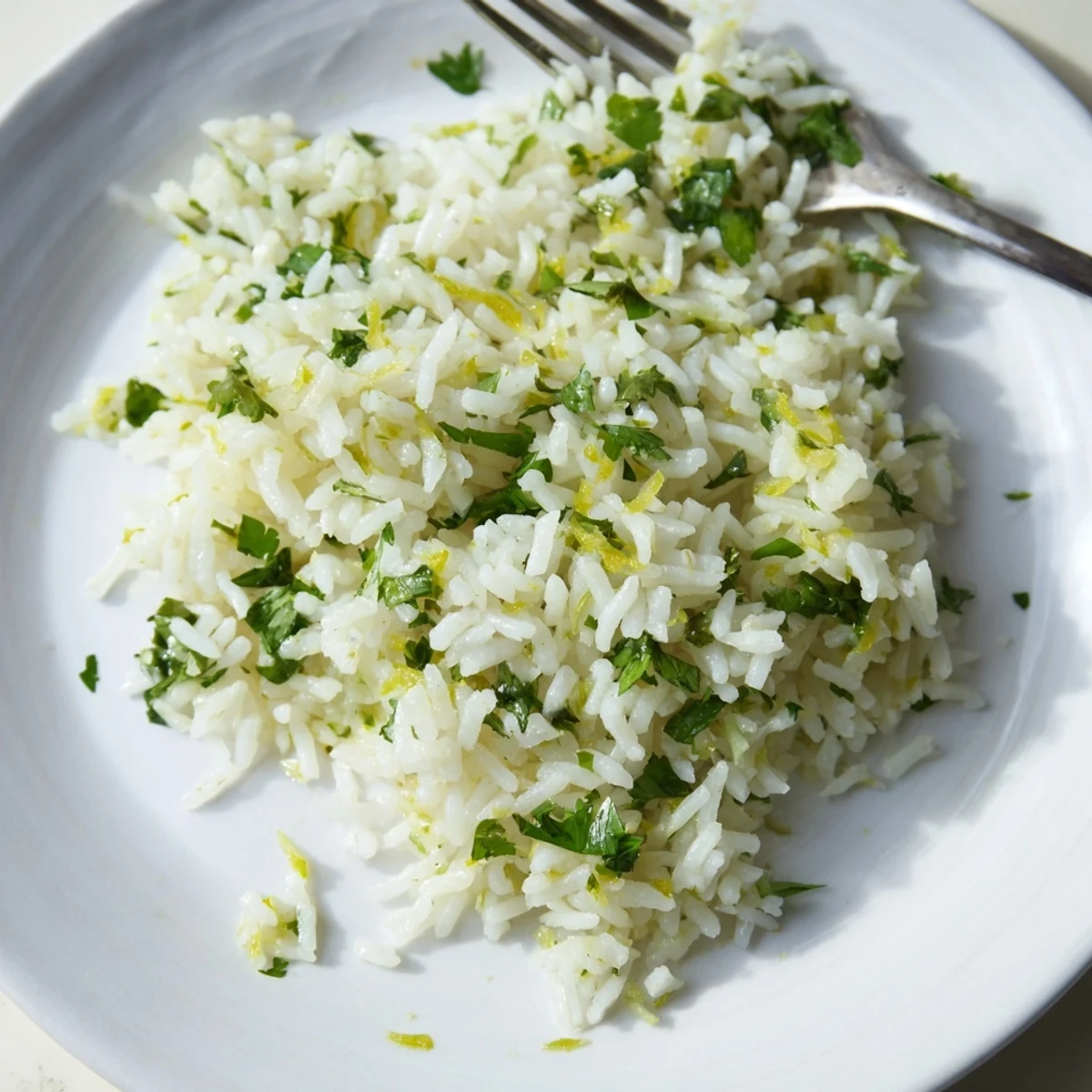 Fluffy white rice mixed with fresh chopped cilantro and bright lime zest for a zesty side dish.