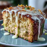 A moist slice of Heavenly Blood Orange Yogurt Cake shows golden crumb and bright orange zest icing, ready to serve.