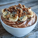 A healthy Chunky Monkey Smoothie Bowl with hemp seeds and mini chocolate chips for a satisfying breakfast.  