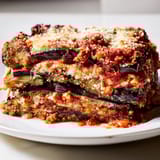 A warm casserole of Eggplant Parmesan Lasagna features tender eggplant, rich sauce, and cheesy goodness.