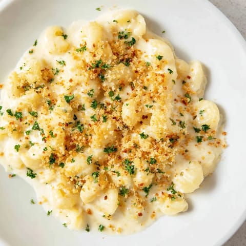 A steaming bowl of rich Truffle Macaroni & Cheese, creamy, cheesy, and infused with truffle aroma.