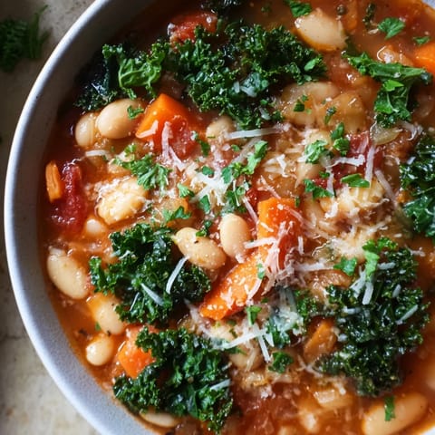 Homemade Italian Bean & Kale Stew, featuring tender beans and kale in a savory tomato broth.
