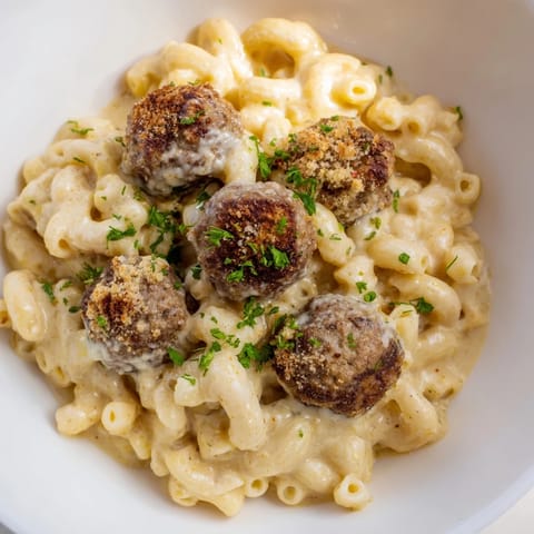 A hearty Mac & Cheese Meatball Bake, featuring a rich cheese sauce and perfectly browned meatballs, steaming hot.